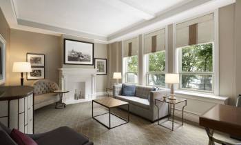 a living room filled with furniture and a large window