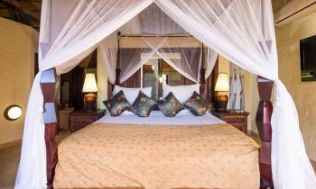 a bedroom with a bed and a curtain