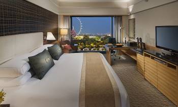 a hotel room with a bed and a flat screen tv