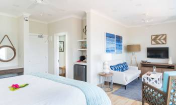 a bedroom with a bed and a chair in a room