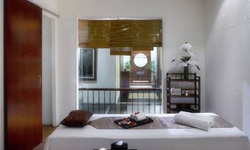 a bedroom with a bed and a mirror