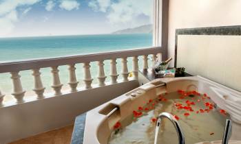 a large white tub sitting next to a window