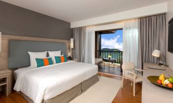 a bedroom with a bed and desk in a hotel room