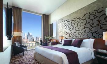 a bedroom with a large bed in a hotel room
