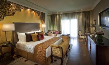 a hotel room filled with furniture and a large window