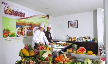 a group of people standing in a kitchen