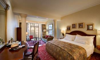 a bedroom with a large bed in a hotel room