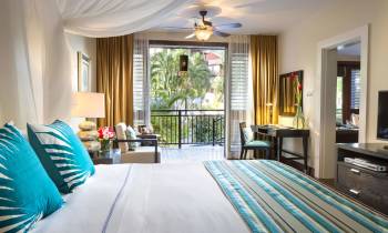 a living room with a bed and a window
