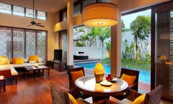 a living room filled with furniture and a fire place and a dining table