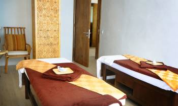 a bedroom with a bed and a chair in a room