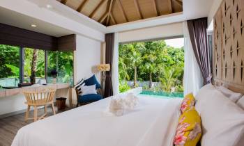 a hotel room with a bed and a window