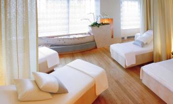 a bedroom with a bed and desk in a room