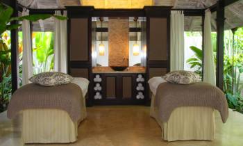a bedroom with a bed and a chair in a room