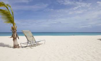 a sandy beach next to a body of water
