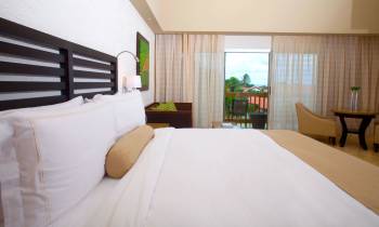 a large white bed in a hotel room