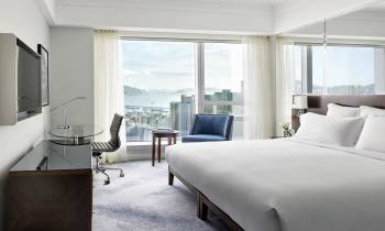 a bedroom with a large bed in a hotel room