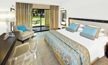 a bedroom with a bed and desk in a room
