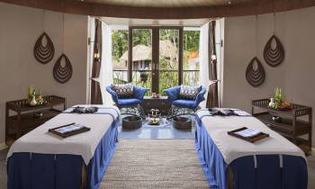 a bedroom with a bed and a table in a room
