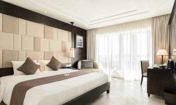 a bedroom with a large bed in a hotel room