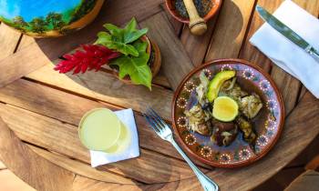 a plate of food sitting on top of a wooden table