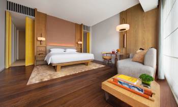 a bedroom with a bed and desk in a room
