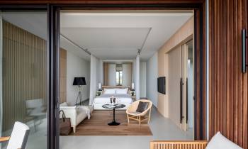 a bedroom with a bed and a mirror in a room