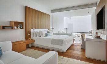 a bedroom with a bed and a mirror in a room