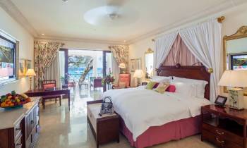 a bedroom with a bed and desk in a room