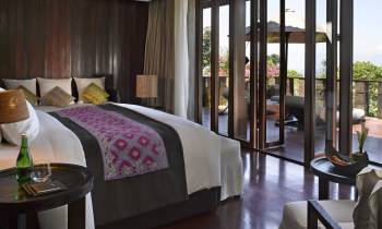 a hotel room filled with furniture and a large window
