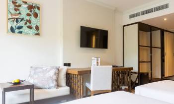 a bedroom with a bed and a chair in a room