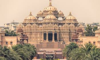 a large building with Akshardham in the background