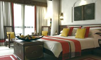 a bedroom with a large bed in a hotel room
