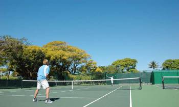 a man with a racket on a court