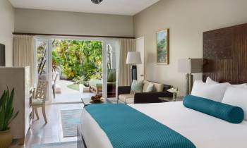 a bedroom with a bed and a chair in a room