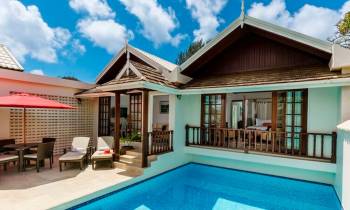 a house with a pool in front of a building