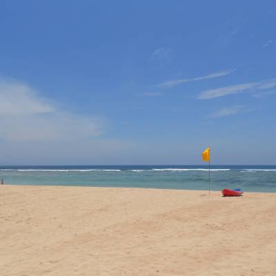 a sandy beach next to the ocean