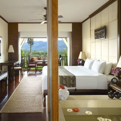a view of a living room with a bed and a mirror