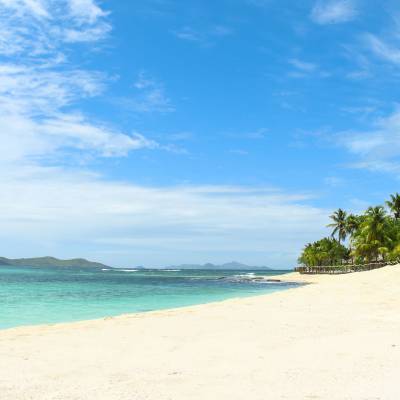 a sandy beach next to the ocean