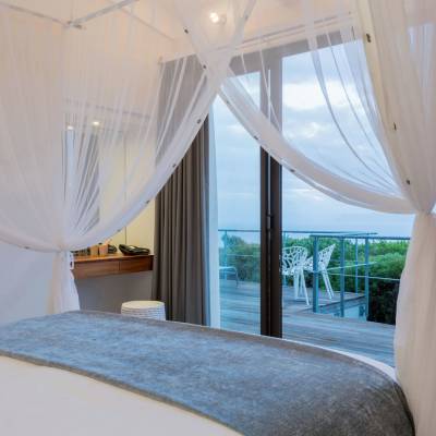a bedroom with a bed and a large window