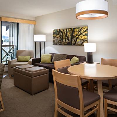 a living area with a desk and chair in a room