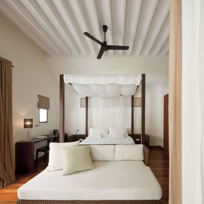a large white bed sitting in a room