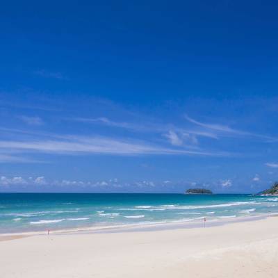a sandy beach next to the ocean