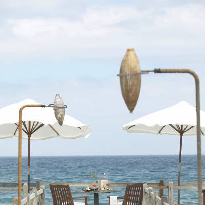 a group of lawn chairs sitting on top of a sandy beach