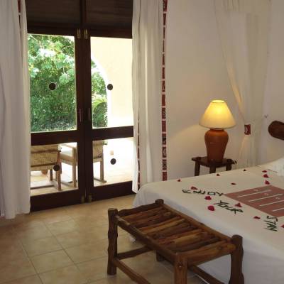 a bedroom with a bed and a table in a room