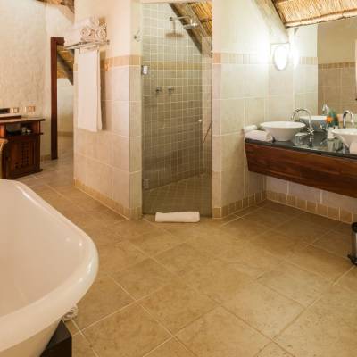 a large white tub sitting next to a sink