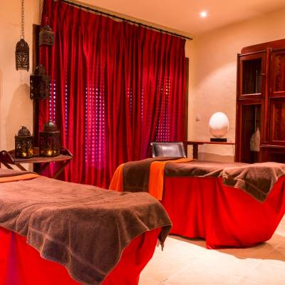 a bedroom with a large red chair in a room