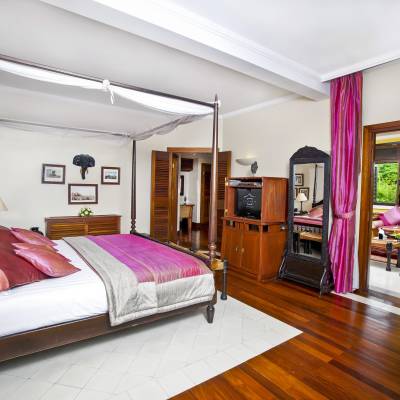 a bedroom with a bed and desk in a room