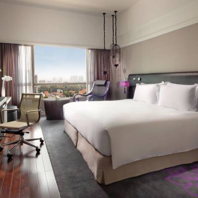 a bedroom with a bed and desk in a room