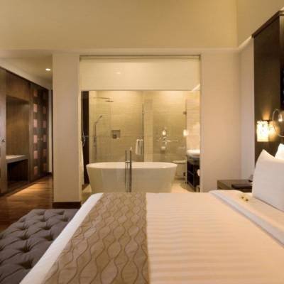 a bedroom with a large bed in a hotel room