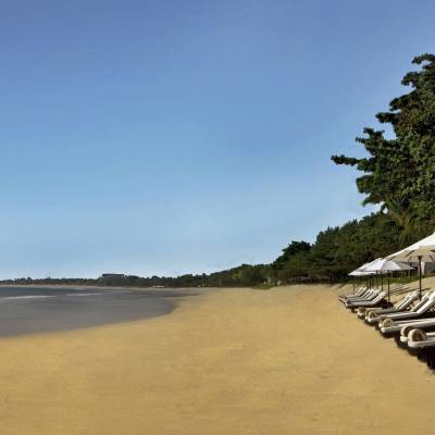 a sandy beach next to a body of water